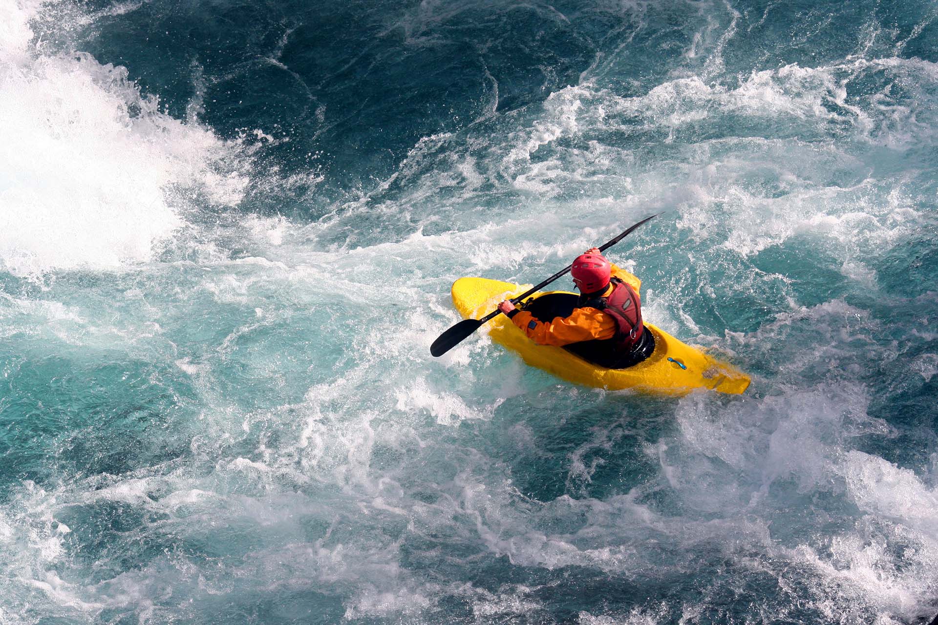 person kayaking in river